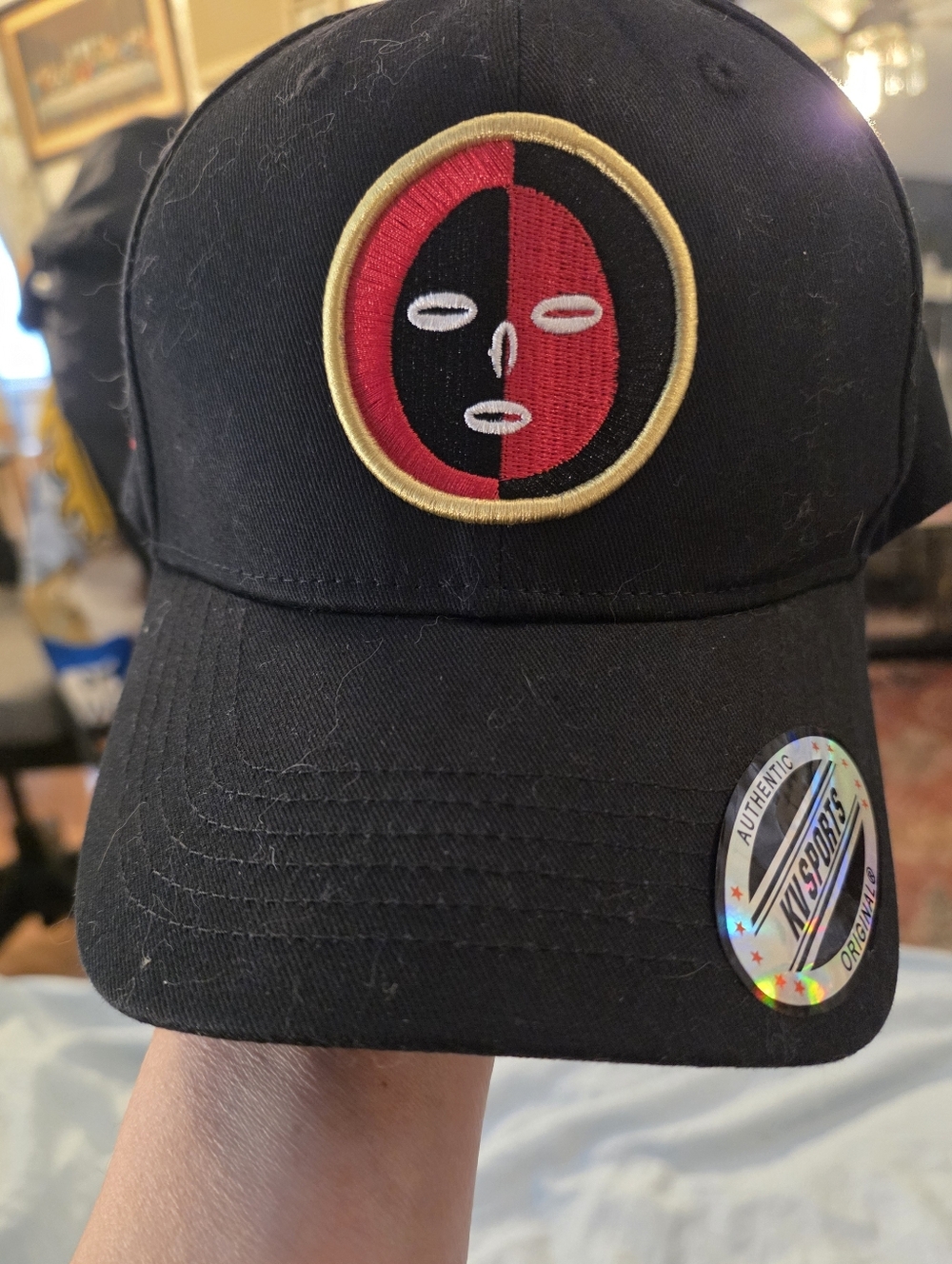 Black Baseball Cap with Red & Gold Split-Face Emblem
